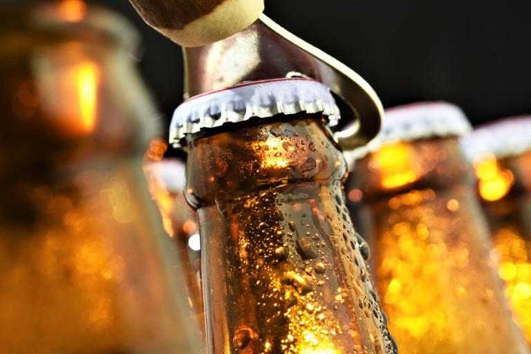 Close up of a beer bottle being opened